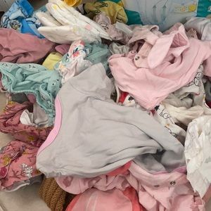 Box full of baby girl clothes , pjs, and onesies.
